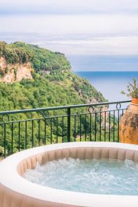 a hot tub with a view of a mountain at Villa San Lorenzo in Scala