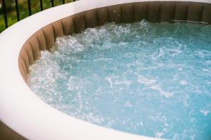 a hot tub with blue water in it at Villa San Lorenzo in Scala