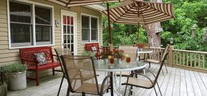 a patio with a table and chairs and an umbrella at Heartstone Inn in Eureka Springs