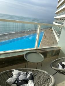 a balcony with a view of a swimming pool at Bamboo Beach Tsikhisdziri in Ts'ikhisdziri