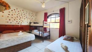 a bedroom with two bunk beds and a window at 4 Estações - Arraial in Arraial do Cabo