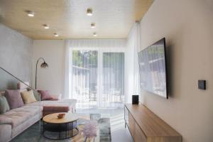 a living room with a couch and a table at Bovi Lux Apartman in Nyíregyháza