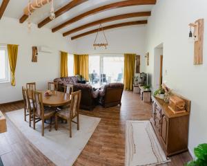 a living room with a table and a couch at Mali Wimbledon in Visoko +22 photos