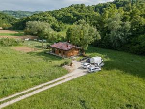 an aerial view of a house with two cars parked in front at Mali Wimbledon in Visoko