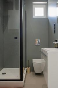 a bathroom with a shower and a toilet and a sink at Bovi Lux Apartman in Nyíregyháza +15 photos
