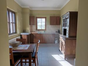 a kitchen with a wooden table and a table and chairs at Gólyaház in Réde