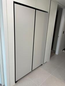 a row of white closet doors with black trim at 광명 스위트하우스 in Gwangmyeong +2 photos