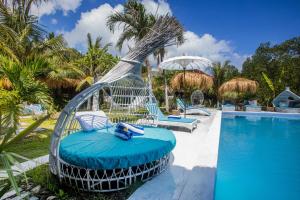 a swing by the pool at a resort at Alinn Villas in Nusa Lembongan