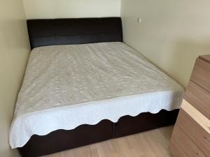 a bed in a small room with a mattress at Palanga poilsiui in Palanga