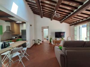 a kitchen and living room with a couch and a table at Il Loggiato del Corso in Città di Castello
