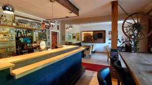 a bar with a wooden counter in a restaurant at Gasthaus Rosenberg in Klotten