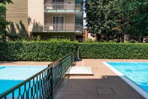 a swimming pool in front of a building at Oasi di Famagosta Milano Navigli in Milan