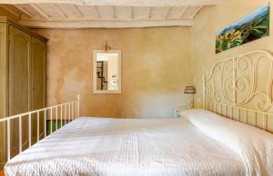 a bedroom with a large white bed in a room at Dimora di Campagna La Cervaiola in Porano +18 photos