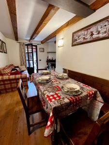 a dining room with a table with plates on it at Le Panoramique, La Salle Derby Village in Villaret