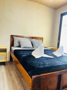 a bed with two pillows on top of it at Coral Stay Bahia Drake in Drake