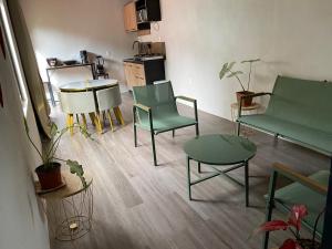 a living room with green chairs and a table at Coral Stay Bahia Drake in Drake +10 photos