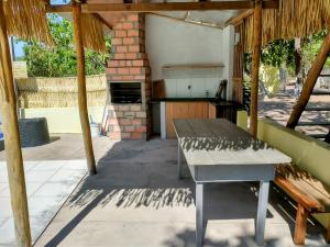 an outdoor kitchen with a table and a stove at Pousada Chacara Cururu in Alter do Chao