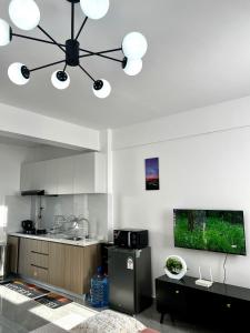 a kitchen with a large chandelier hanging from the ceiling at Zen Studio for your Rest and Unwind in Nairobi +3 photos