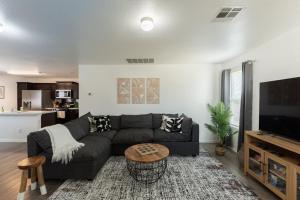 a living room with a couch and a table at Valley Forest 65in TV Games Lackland Pet in San Antonio