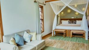 a living room with a bed and a couch at Mateves boutique lodge in Arusha