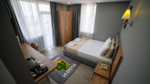 a small bedroom with a bed and a table and window at La Cactus Boutique Hotel in Antalya +29 photos