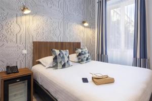 Postel nebo postele na pokoji v ubytování Best Western Plus Hôtel Brice Garden Nice