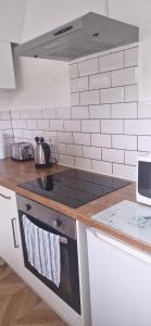 a kitchen with a stove top oven in a kitchen at Uxbridge Studio Flat in Cowley