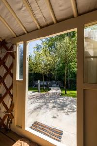 an open door with a view of a patio at Yurt with Hot Tub near Hartington, Peak District in Buxton