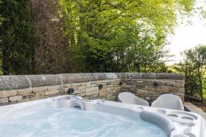 a jacuzzi tub in a stone wall at Yurt with Hot Tub near Hartington, Peak District in Buxton