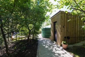 a small wooden building with a green dome at Yurt with Hot Tub near Hartington, Peak District in Buxton