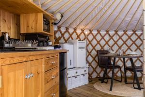 a kitchen with a table in a yurt at Yurt with Hot Tub near Hartington, Peak District in Buxton