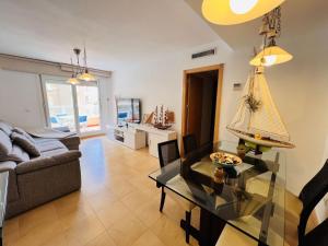 a living room with a couch and a table at Punta Cormoran by Alina365 in La Manga del Mar Menor