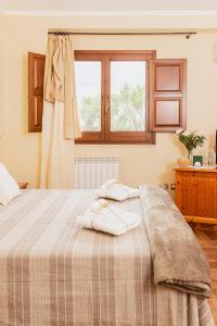 a bedroom with a bed with two towels on it at Il Casale Colle San Pietro in San Pietro