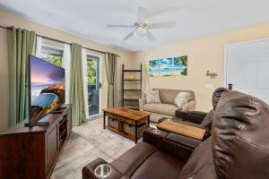 a living room with a couch and a flat screen tv at Big Island Fairway Terrace A-202 by Coldwell Banker Island Vacations in Waikoloa Village