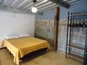 a room with a bed with a yellow sheet on it at Residencial Villa Cantareira in Caieiras +280 photos