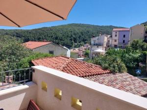 a balcony of a building with a view of a city at House Valun 42 in Valun