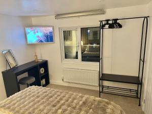 a bedroom with a bed and a desk and a window at THE ANNEXs in Bray