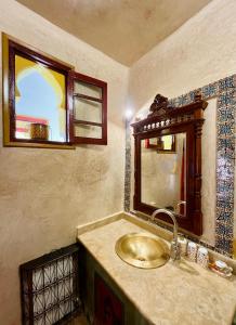 a bathroom with a sink and a mirror at Dar Meziana in Chefchaouen +67 photos