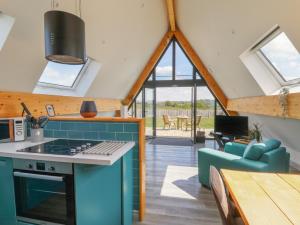 a kitchen and living room with a couch and a table at Kerry Hill - The Sheepfold in Llandrindod Wells