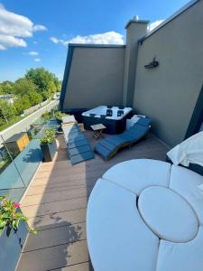 a patio with a couch and a table on a balcony at Unique House for Football Fans-Wroclaw Final- near Stadium in Wrocław