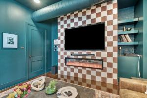 a living room with a fireplace with a tv at Nashville Studio B Suite 4BR by Maddox Hotel in Nashville