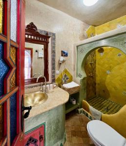 a bathroom with a sink and a shower at Dar Meziana in Chefchaouen