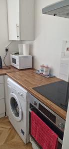 a kitchen with a washing machine and a microwave at Langley One Bedroom Flat in Langley Station +10 photos