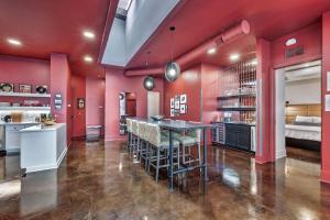 a kitchen with red walls and a table and chairs at Nashville Elvis Suite 4BR by Maddox Hotel in Nashville