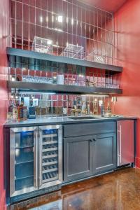 a kitchen with red walls and a counter with a counter at Nashville Elvis Suite 4BR by Maddox Hotel in Nashville