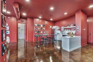 a kitchen with red walls and a bar with stools at Nashville Elvis Suite 4BR by Maddox Hotel in Nashville +28 photos