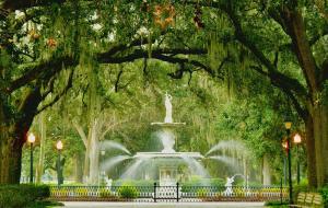 a fountain in the middle of a park with trees at Stunning Forsyth Park Victorian - Walk to it all! in Savannah +17 photos