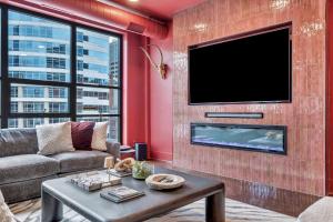 a living room with a couch and a tv at Nashville Elvis Suite 4BR by Maddox Hotel in Nashville