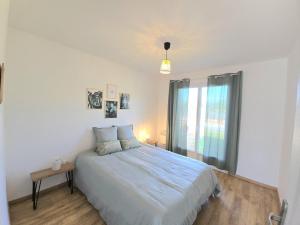 a bedroom with a large bed and a window at Maison périgourdine avec piscine privative, internet et animaux acceptés - FR-1-616-476 in Sainte-Sabine