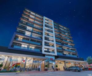 a tall building with a car parked in front of it at Apartment JC 903: Jardim Camburi. Vitória- E.S. in Carapina